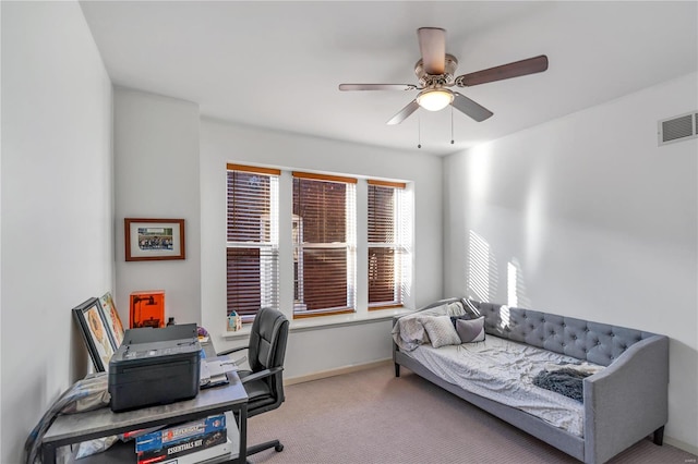 carpeted office featuring ceiling fan