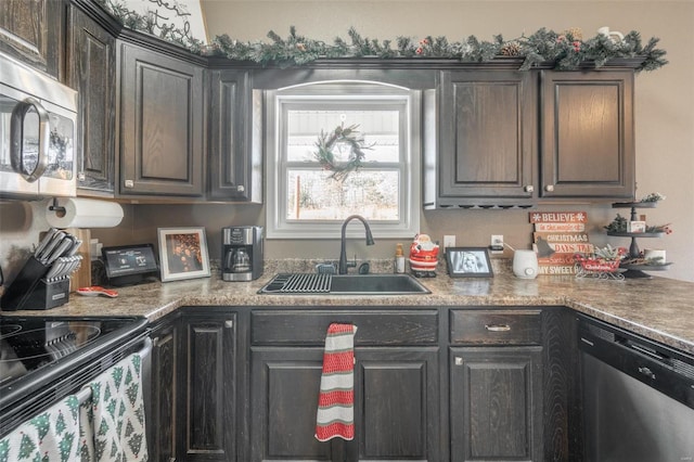 kitchen featuring dark brown cabinetry, sink, and appliances with stainless steel finishes