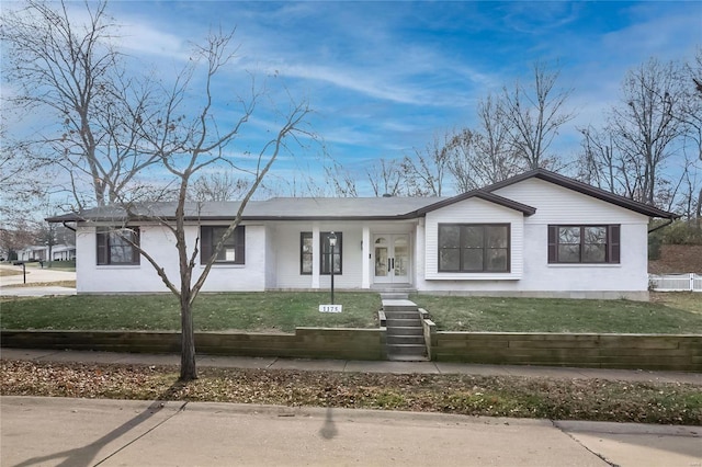 ranch-style house with french doors and a front lawn