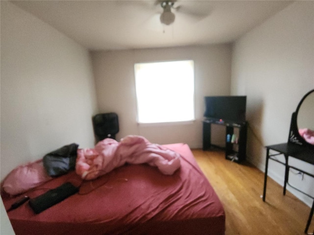 bedroom with a ceiling fan and wood finished floors