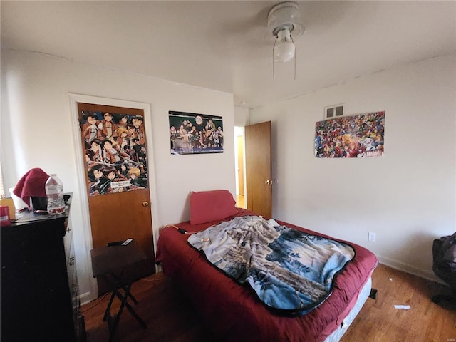 bedroom featuring wood-type flooring and ceiling fan