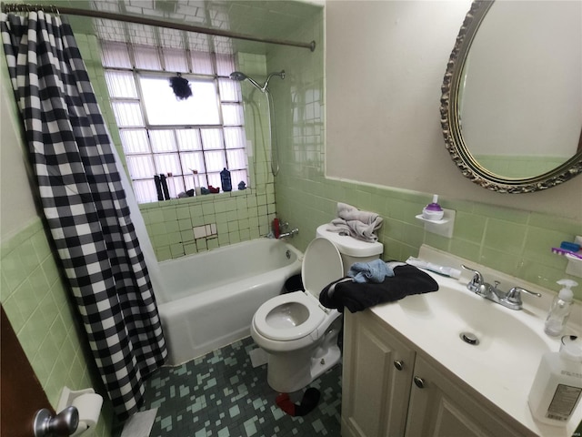 full bathroom with shower / bathtub combination with curtain, tile walls, vanity, tile patterned floors, and toilet