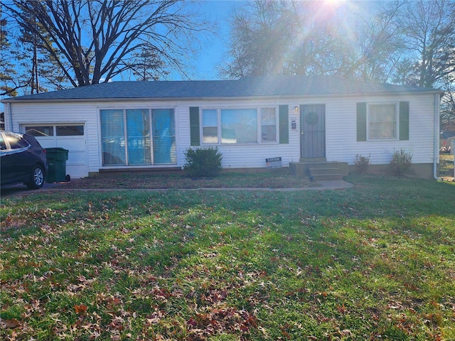 ranch-style home with a garage, entry steps, and a front lawn