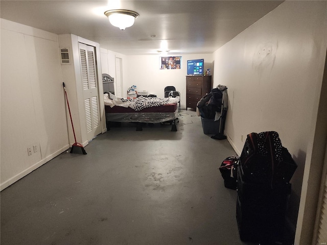 bedroom featuring concrete flooring