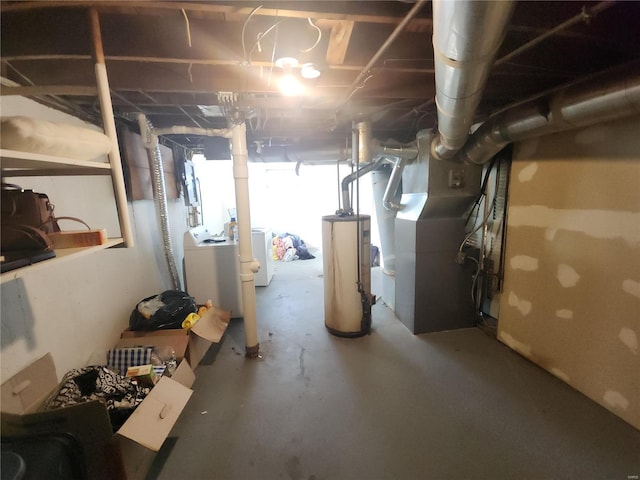 basement with heating unit, water heater, and washer / clothes dryer