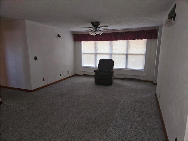 unfurnished room featuring a textured ceiling, carpet floors, and ceiling fan