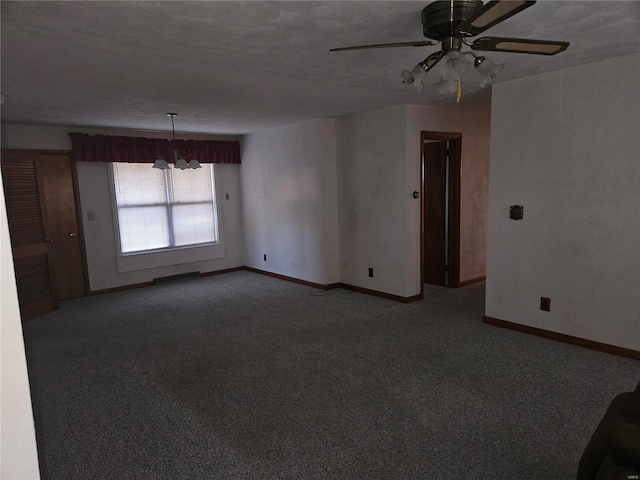 empty room with carpet, a textured ceiling, and ceiling fan with notable chandelier