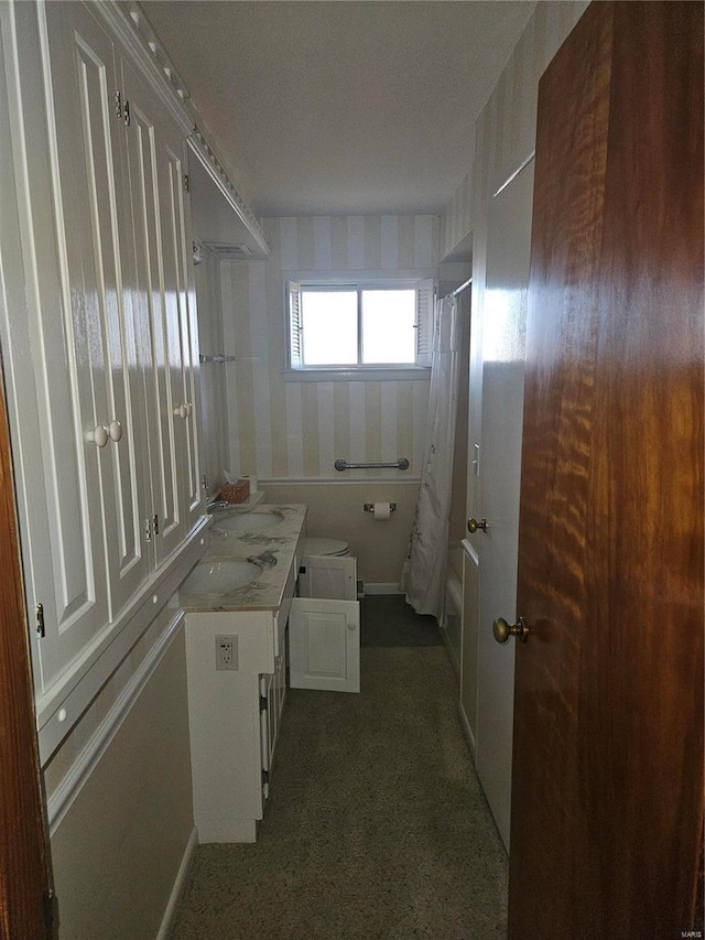 bathroom featuring vanity and shower / bathtub combination with curtain