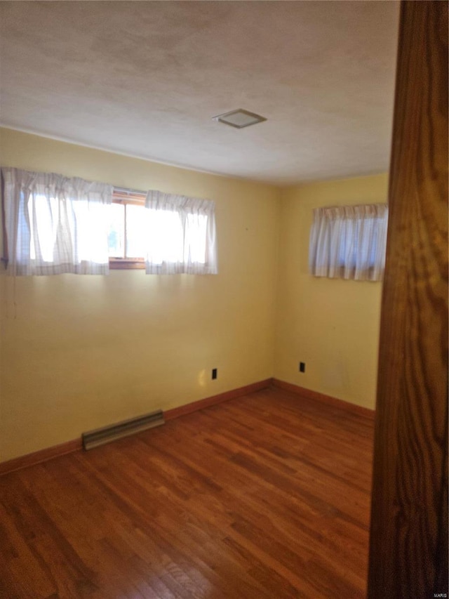 spare room with wood-type flooring