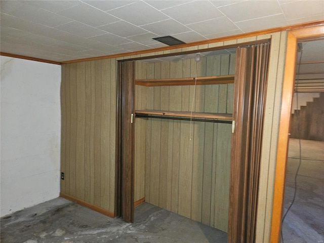 basement featuring wood walls