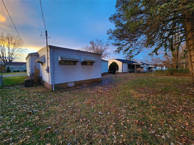 rear view of property featuring central AC unit and fence