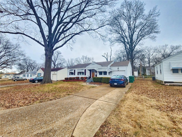 view of front of home with driveway, an attached garage, and a residential view