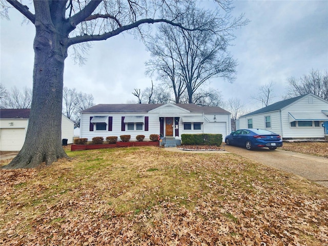 single story home featuring an attached garage, driveway, and a front lawn