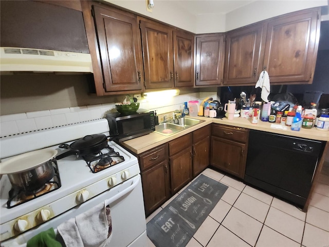 kitchen featuring light tile patterned floors, under cabinet range hood, light countertops, black appliances, and a sink