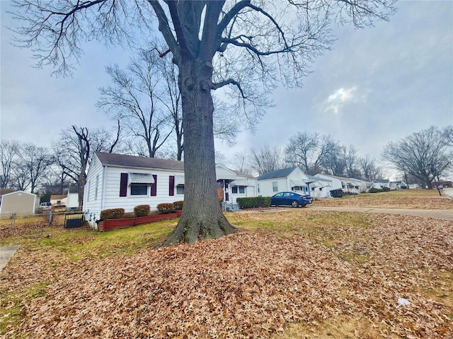 view of front of house with a residential view and fence