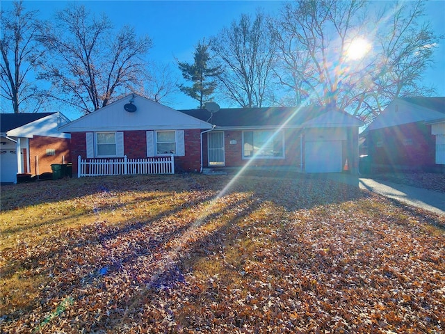 ranch-style house with driveway and brick siding