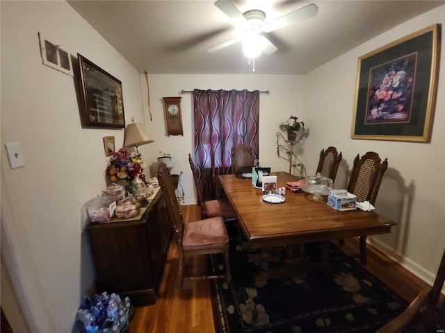 dining area with dark wood-style floors, ceiling fan, visible vents, and baseboards