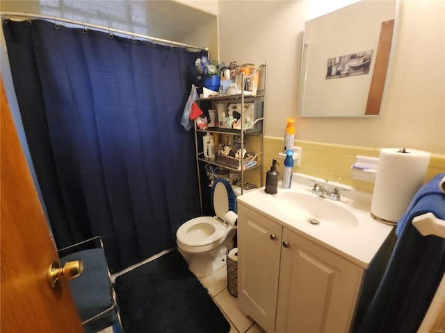 bathroom featuring toilet, vanity, tile walls, and tile patterned floors