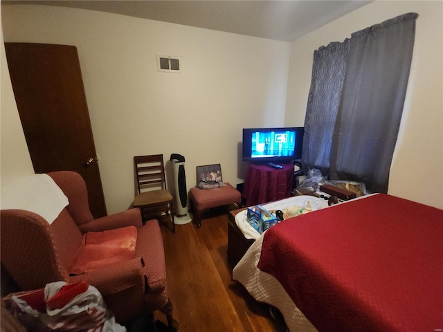 bedroom with visible vents and wood finished floors