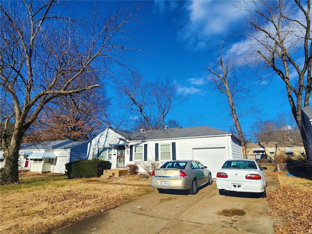 single story home with driveway and a garage