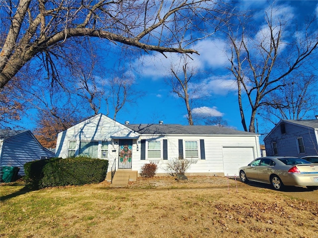 ranch-style house featuring a front yard and an attached garage