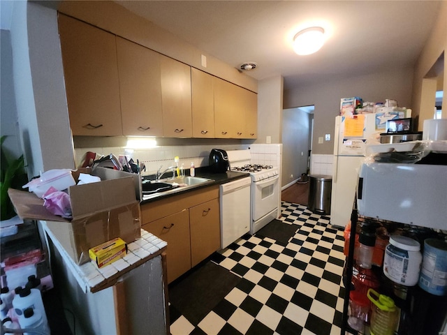 kitchen with white appliances, cream cabinetry, sink, and backsplash