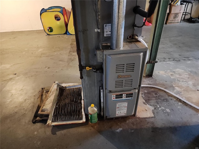 utility room featuring heating unit