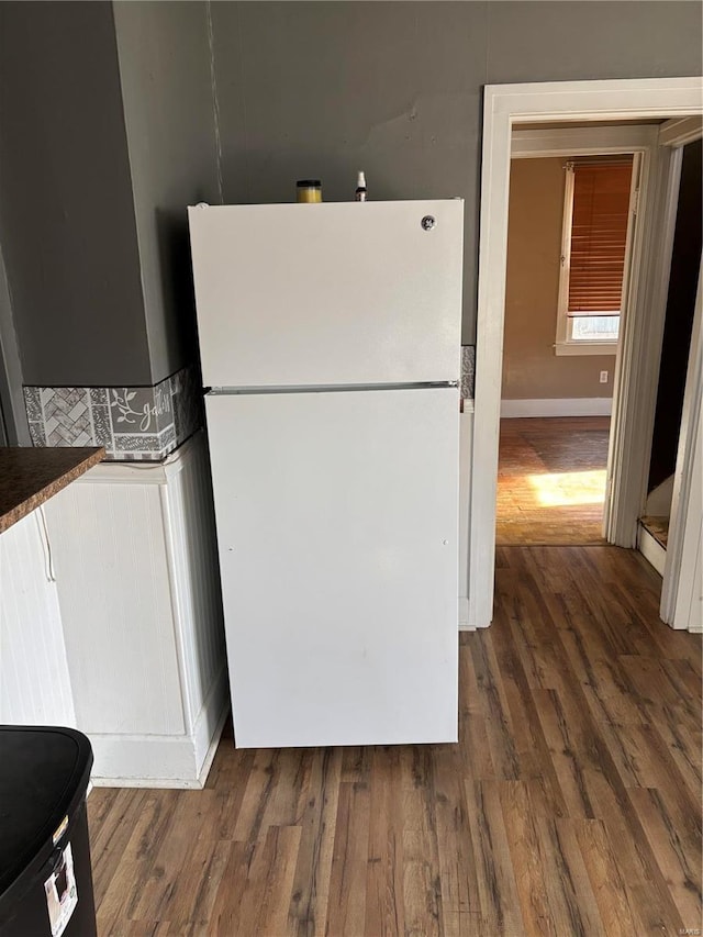 kitchen with dark hardwood / wood-style floors and white refrigerator