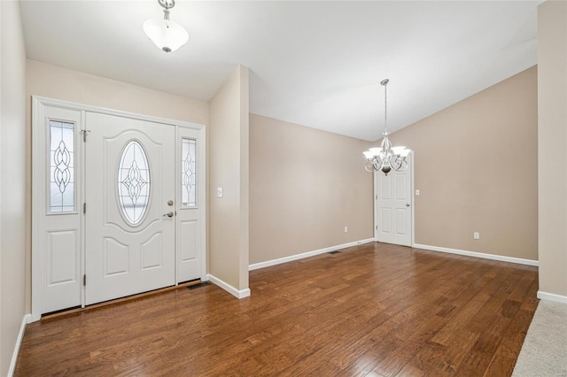 foyer featuring dark hardwood / wood-style flooring and a notable chandelier