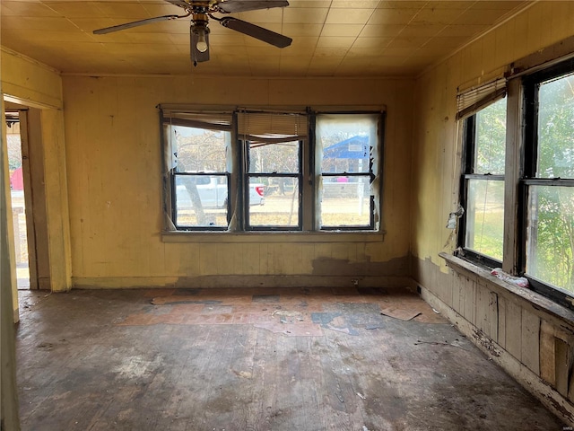 spare room with ceiling fan and a healthy amount of sunlight