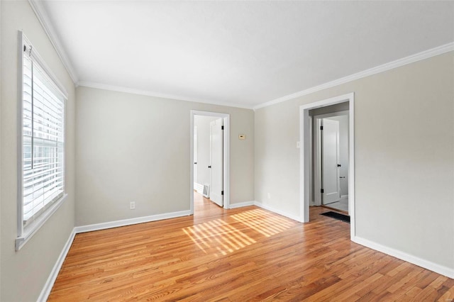 unfurnished room featuring light hardwood / wood-style floors and ornamental molding