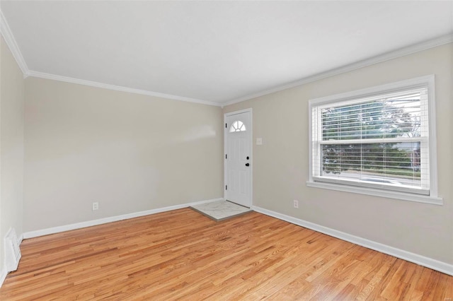 foyer with light wood-type flooring and ornamental molding