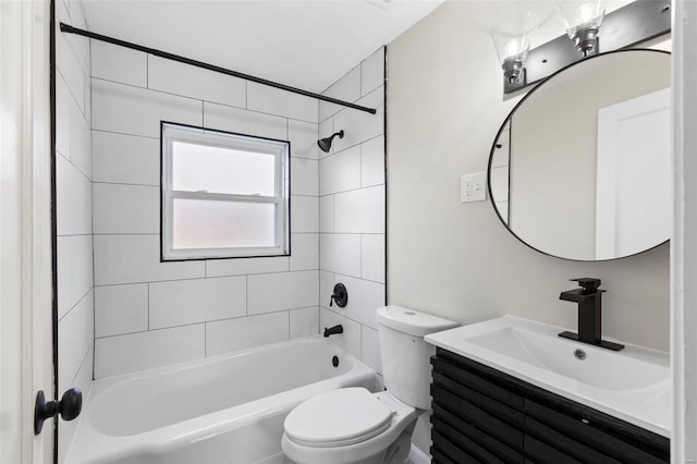 full bathroom featuring vanity, toilet, and tiled shower / bath combo