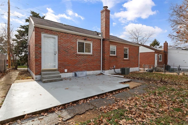 rear view of property with central AC and a patio area