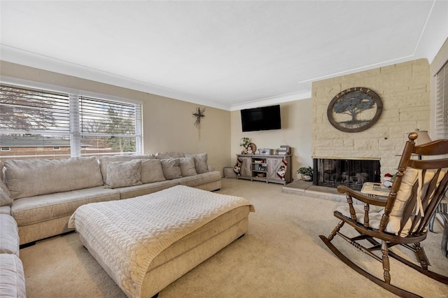 living room featuring a stone fireplace, light colored carpet, and crown molding