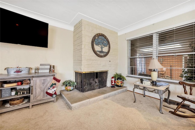 living room featuring light colored carpet and a fireplace