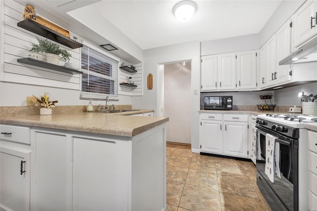 kitchen with wall chimney range hood, white cabinetry, and black appliances