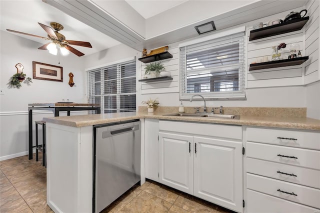 kitchen featuring kitchen peninsula, white cabinets, ceiling fan, sink, and dishwasher