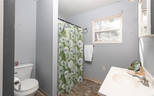 bathroom featuring vanity, curtained shower, and toilet