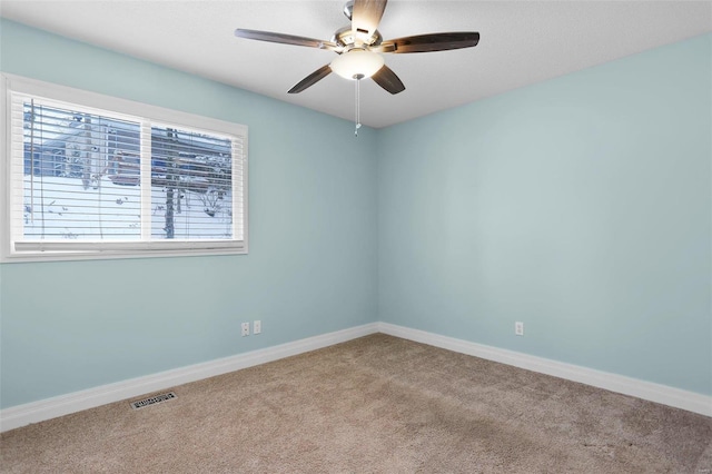 empty room with ceiling fan and carpet