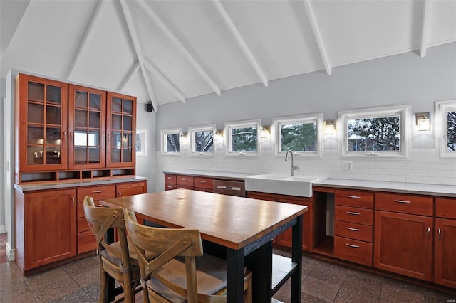 dining room featuring sink, high vaulted ceiling, and beam ceiling