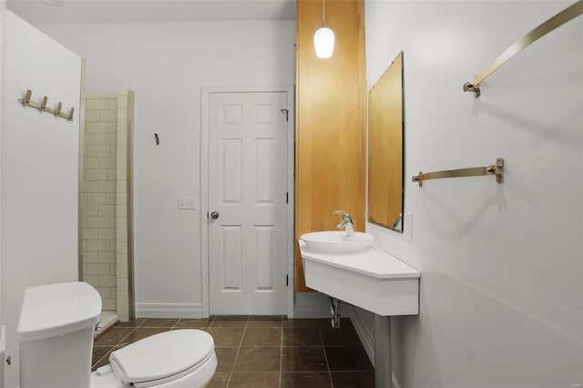 bathroom featuring sink, tile patterned flooring, and toilet