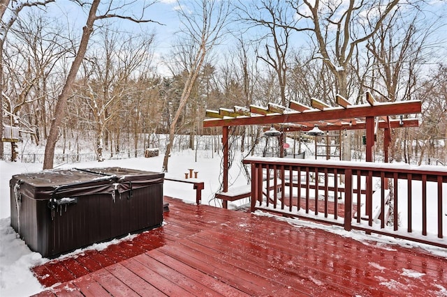 snow covered deck with a pergola and a hot tub