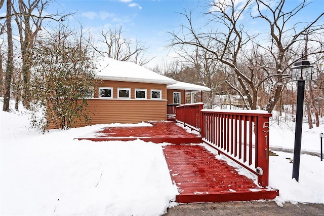 yard covered in snow featuring a wooden deck