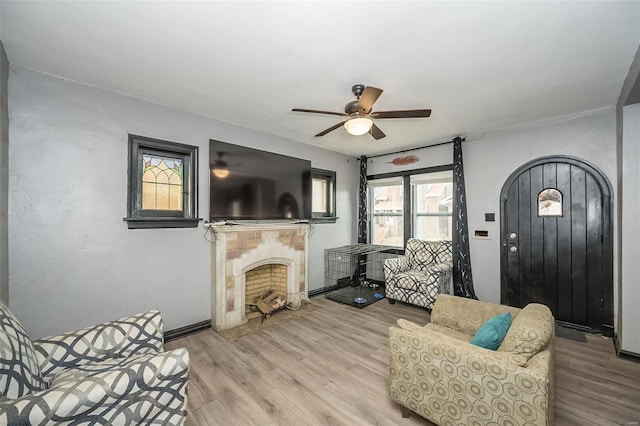 living room featuring ceiling fan and light hardwood / wood-style flooring