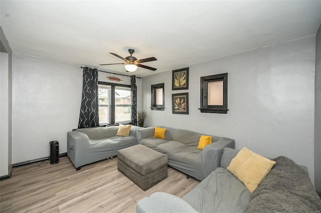 living room featuring ceiling fan and light hardwood / wood-style flooring