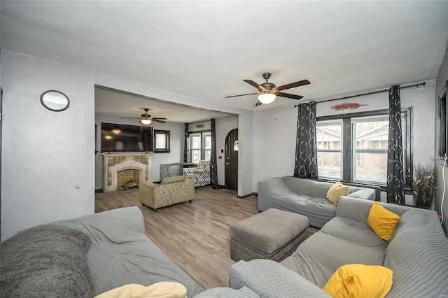 living room featuring ceiling fan and light hardwood / wood-style flooring