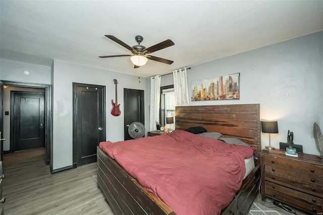 bedroom with ceiling fan and light hardwood / wood-style floors