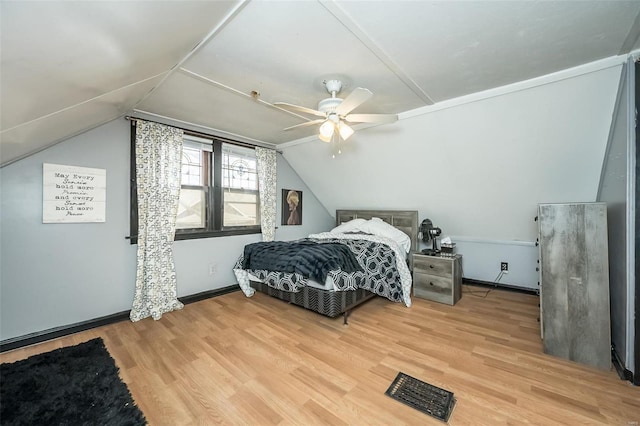 bedroom featuring hardwood / wood-style floors, ceiling fan, and lofted ceiling