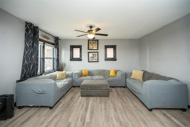 living room with light wood finished floors and a ceiling fan